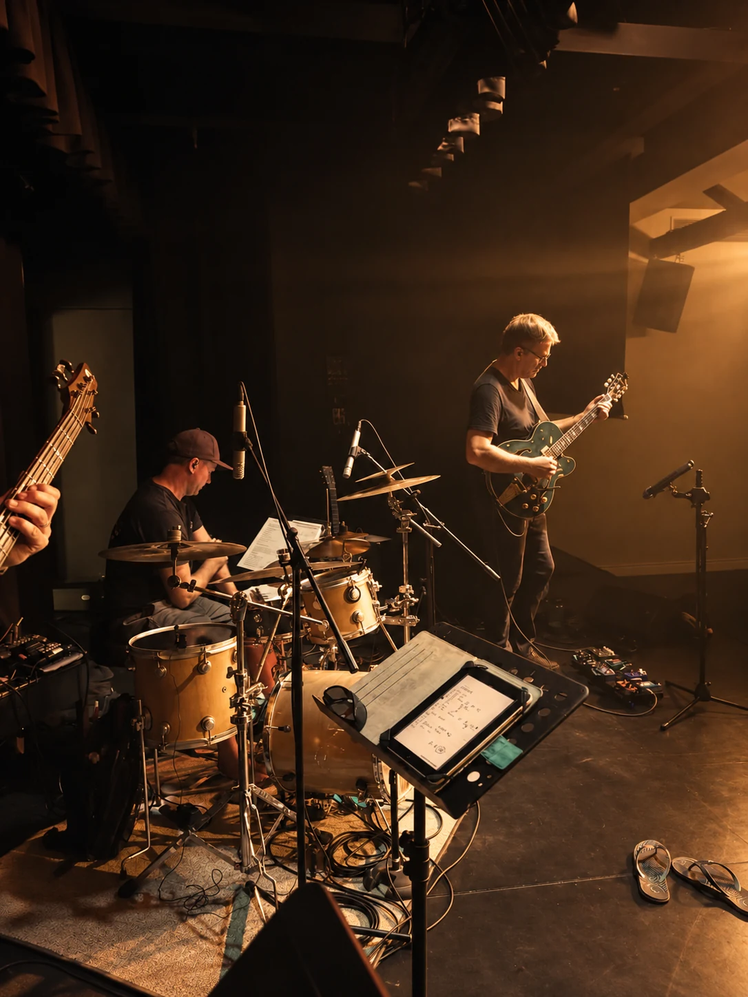 Sven Blumer rehearsing with musicians under warm stage lighting